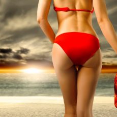 Asses of girls at beach wearing bikini panties  
