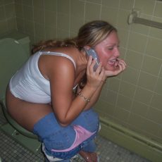 Amateurs sitting on the toilet with lowered panties 